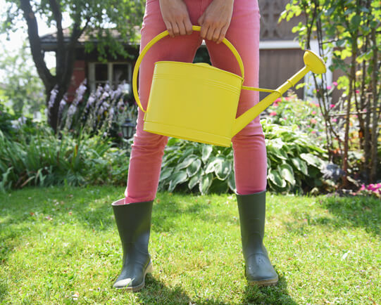 young-woman-holding-watering-can
